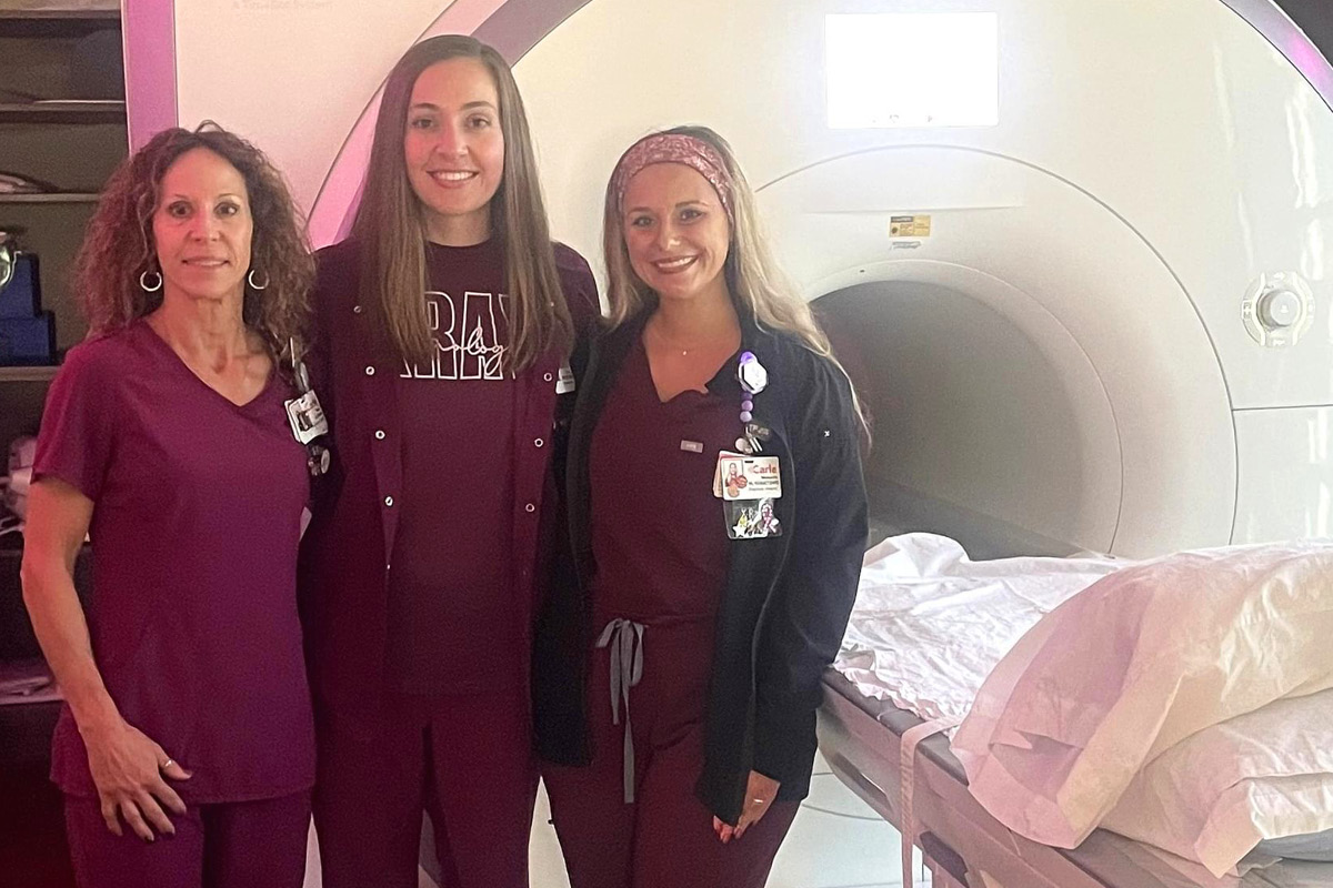 Carle Health team members stand by an MRI machine.