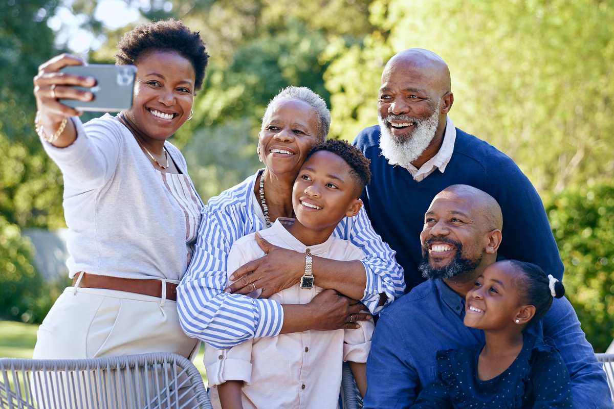 Senior couple taking a selfie with family.