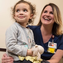 Nurse and child smiling 